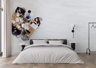 Top view of group of multiethnic busy people working in an office, Aerial view with businessman and businesswoman sitting around a conference table with blank copy space, Business meeting concept Wall mural