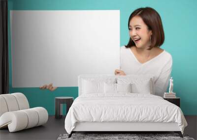 Young attractive asian woman showing and holding blank white board, Showing empty board for input your text Wall mural