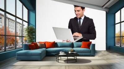 Young business man in suit using laptop computer on hand isolated on white background Wall mural