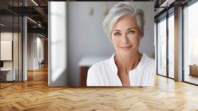 Beautiful mature woman in her 50s with short gray hair and perfect skin in a modern bathroom Wall mural