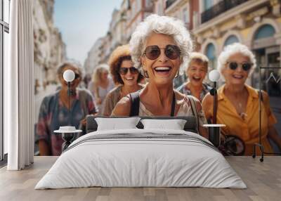 Happy 70 years old female multi-racial group walking with travel bag in the street of an european city. Senior people and mature travel. Wall mural