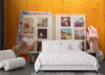 Top view of a senior caucasian woman looking at an old photo album themes of memories nostalgia photos retired Wall mural