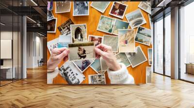 Top view of a senior caucasian woman looking at an old photos themes of memories nostalgia photos retired Wall mural