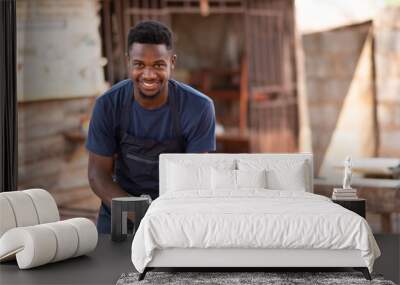 portrait of an african carpenter smiling while working Wall mural