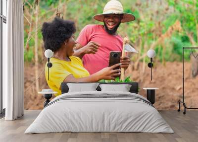 two african farmers excited after checking a phone Wall mural