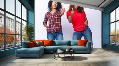 two excited young black women give thumbs up Wall mural