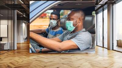 two people, african driver and passenger wearing face masks Wall mural