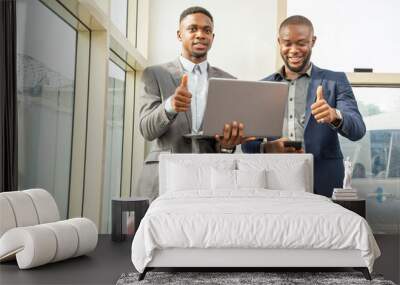 two young black business men standing together giving thumbs up Wall mural