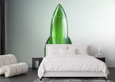 Green glass rocket sculpture on light background. Wall mural