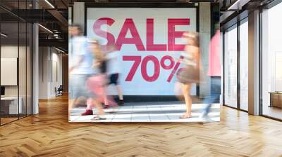 Shop sale sign, motion blurred pedestrians Wall mural