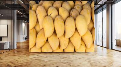 purchase of tropical fruits in the markets of Asia. Mango fruits for cooking and eating Wall mural