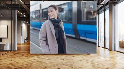 Attractive woman standing on an urban street Wall mural