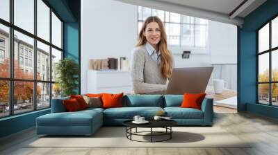 Friendly young businesswoman with a quiet smile Wall mural