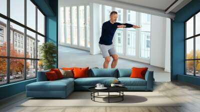 Man doing balance and muscle control exercises Wall mural