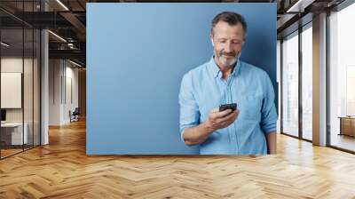 Man listening to music or media on his mobile Wall mural