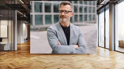 mature metro man with arms folded in urban street Wall mural