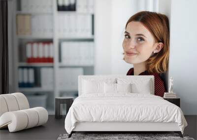 Pretty young businesswoman with a quiet smile Wall mural