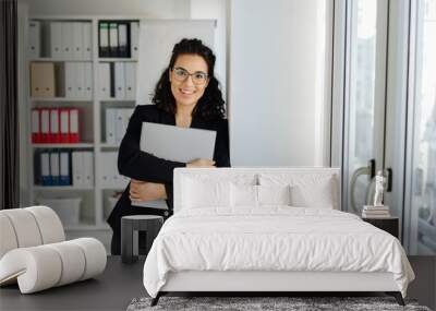 Relaxed young businesswoman with a friendly smile Wall mural