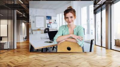 Relaxed young office worker with a sweet smile Wall mural