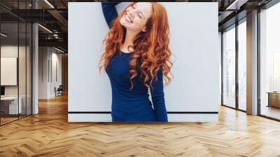 Slender sexy young woman with curly long red hair Wall mural