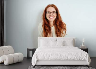 Smiling friendly young woman wearing spectacles Wall mural