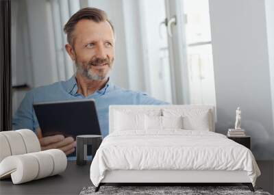 Thoughtful senior man looking aside as he relaxes Wall mural