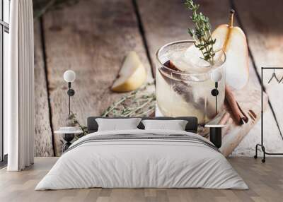 Cold pear white tea with thyme, cinna mon and honey on the olive desk and wooden background Wall mural