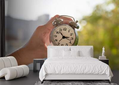 hands adjusting or changing the time on clock Wall mural