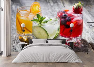 assortment of fresh iced fruit drinks on wooden background Wall mural