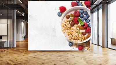 muesli with yogurt and berries for breakfast on white background, top view Wall mural