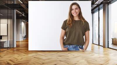 attractive modern young urban woman chestnut short haircut wearing olive t-shirt holding hands pocke Wall mural