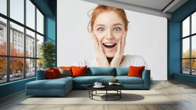 Close up portrait of surprised happy freckled redhead girl Wall mural