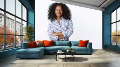 Friendly cheerful attractive african american curly-haired young 25s woman consultant woking talking coworkers smiling pleasant having fun enjoying relaxing company mood, standing hands crossed chest Wall mural