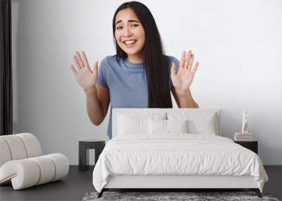 Girl trying jokingly refuse strange offer, step back and laughing awkward, raising hands up in surrender or rejection, smiling silly apologizing for not coming to party, standing white background Wall mural