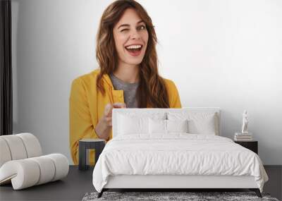 Gotcha. Hey wanna be friends. Cheeky confident relaxed young party girl smiling broadly winking approval pointing camera finger pistols you nice work gesture approve great choice, white background Wall mural