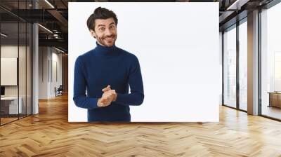 Handsome good-looking stylish caucasian guy in blue high neck sweater, rubbing hands and smiling politely, want sale something, making good deal, suggesting buy product, stand white background Wall mural