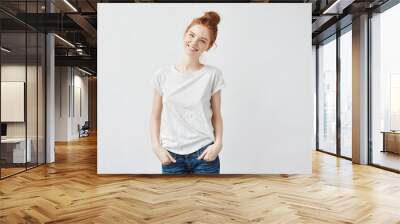 Happy redhead girl smiling looking at camera.  Wall mural