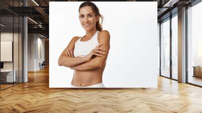 Middle aged fitness woman in sport activewear, cross arms on chest and smiling, being healthy and fit, training and exercising, white background Wall mural