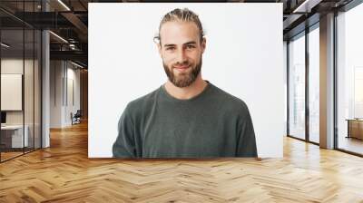 Portrait of beautiful mature blonde bearded guy with trendy hairdo in casual grey shirt smiling and looking in camera. Wall mural