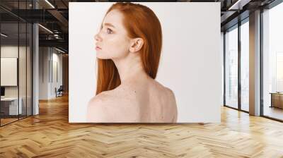 portrait of beautiful young woman with long red healthy hair and pale skin, showing clean smooth bac Wall mural