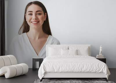 portrait of happy beautiful young businesswoman smiling looking at camera over white background. Wall mural