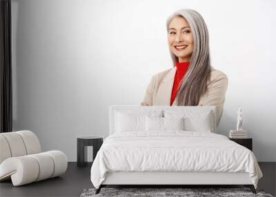 Portrait of professional asian senior businesswoman, cross arms on chest, looking confident, wearing stylish suit, smiling assertive, working in corporate, white background Wall mural