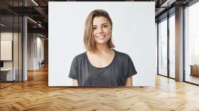 Portrait of young beautiful cute cheerful girl smiling looking at camera over white background. Wall mural