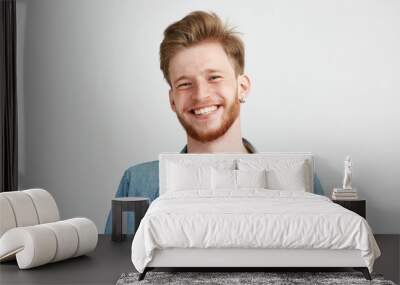 Portrait of young handsome hipster man with beard smiling laughing looking at camera over white background. Wall mural