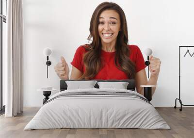 Sentimental upbeat brunette girl fist pump, smiling happily achieve goal, winning competition, triumphing joyfully from successful accomplishment, standing white background in red t-shirt Wall mural