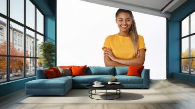 Smiling Black girl in yellow t-shirt standing confident, looking happy and confident, arms crossed over chest, white background Wall mural