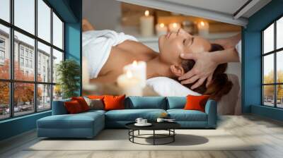 young beautiful girl having face massage relaxing in spa salon. Wall mural