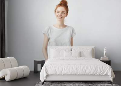 Young beautiful redhead girl smiling.  Copy space. Wall mural