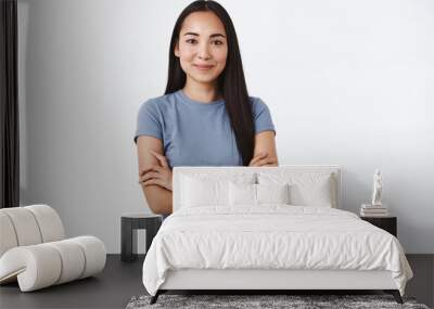 Young confident and determined asian girl start her first day work, assertive everything go well, cross hands chest in self-assured pose, smiling pleased, stand white background Wall mural