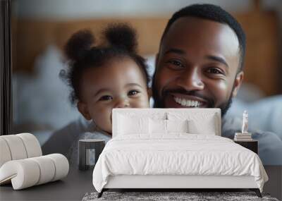 Happy loving young African American dad holding adorable smiling kid Wall mural